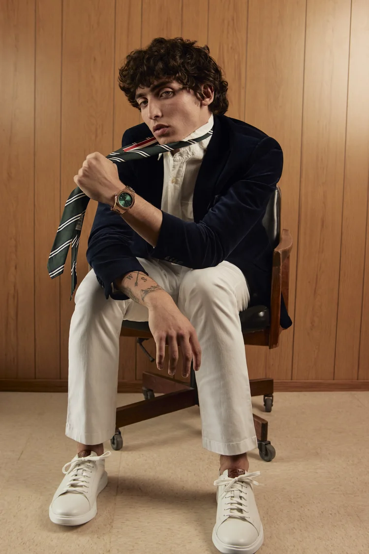 Louis Cartel — man in dark blazer on wooden chair