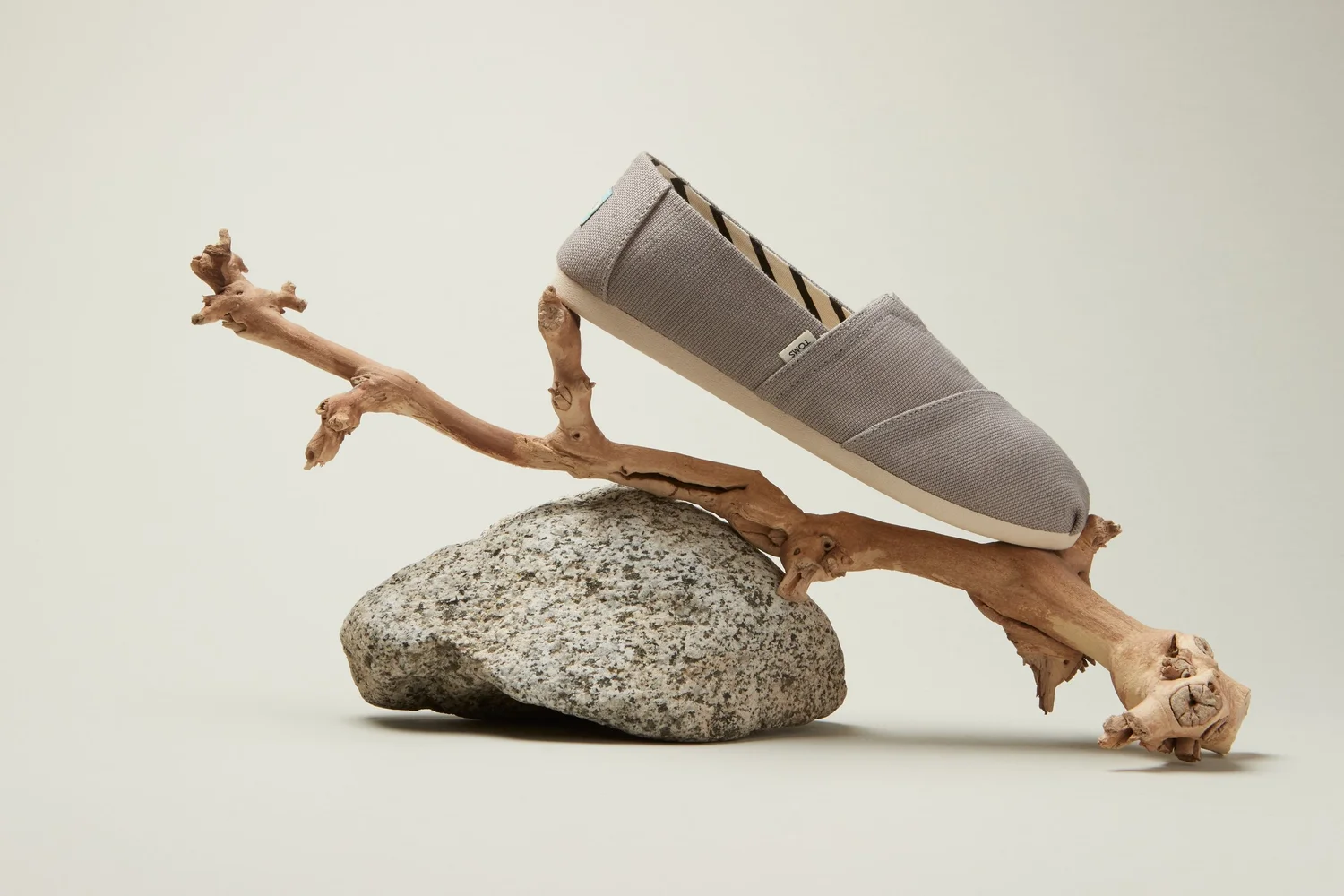 TOMS slip-on balanced on driftwood
